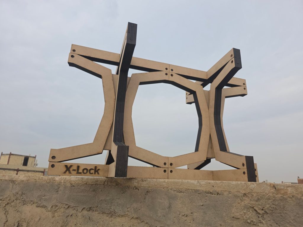 pale panel-built X-Lock module stands on a ledge against a light sky